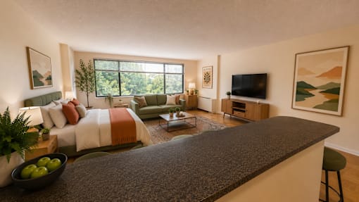 A modern living room with a large window and a grey counter.