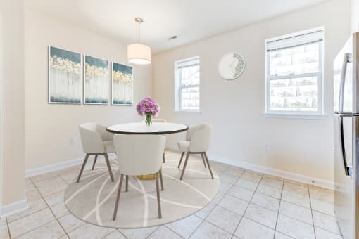 dining area with table, chairs, windows and tile flooring at sheridan station south townhomes in washington dc