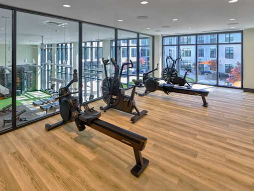 A gym with wooden floors and a view of the city.