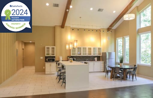 A modern kitchen with a dining area and a Satisfacts 2024 Satisfaction Award badge.