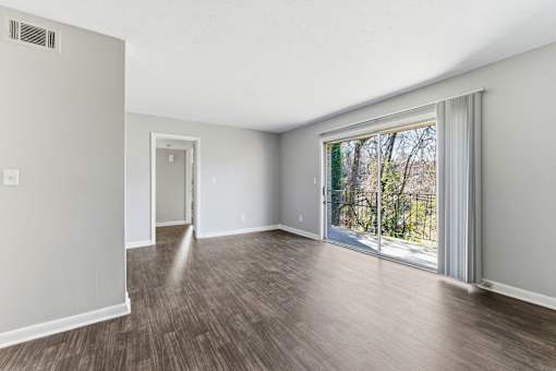 Room with sliding glass door and wooden floor at The Reserve at Brookhaven, Atlanta, GA, 30329