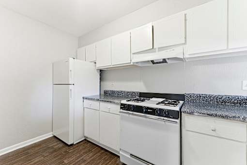 Kitchen with white appliances at The Reserve at Brookhaven, Atlanta