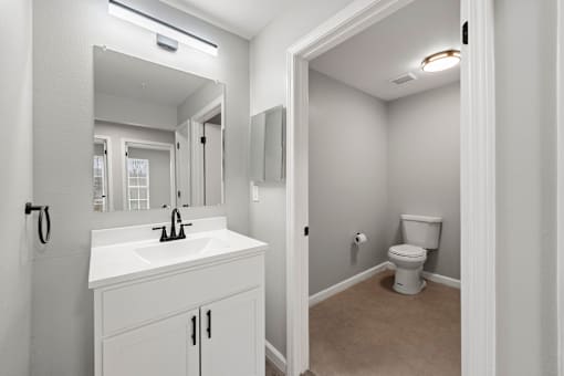 Bathroom sink with mirror at 2000 Oasis Apartments, Atlanta, 30316