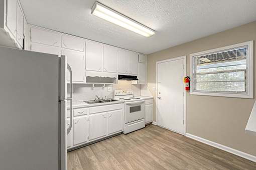 Spacious kitchen with white appliances at Balfour 296, Lilburn, Georgia 30047