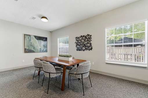 A dining room with a wooden table and chairs.
