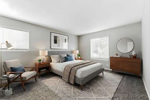 Bedroom with chair at Lacota Apartments, Atlanta, GA, 30360