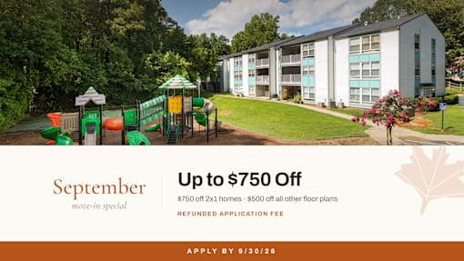 Playground and apartment buildings with green lawn at Concord Crossing Apartments, Smyrna, GA