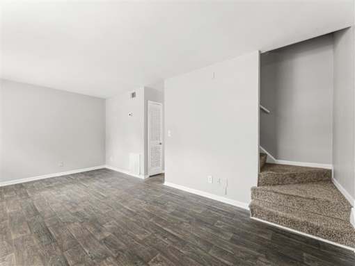 Room with carpeted staircase at Pinewood Townhomes, Tucker, Georgia