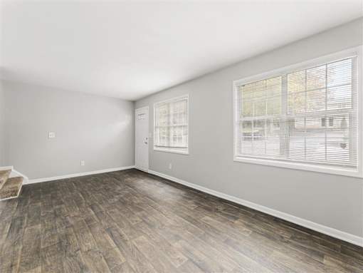 Bright room with window and wooden floor at Pinewood Townhomes, Tucker, GA