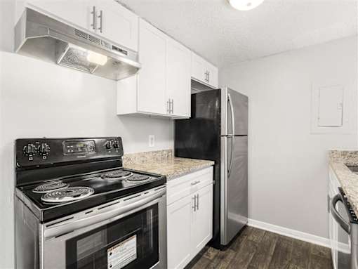 Kitchen with black stove at Pinewood Townhomes, Tucker