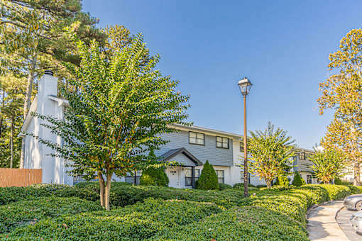 House with greenery at Pinewood Townhomes, Tucker, GA, 30084
