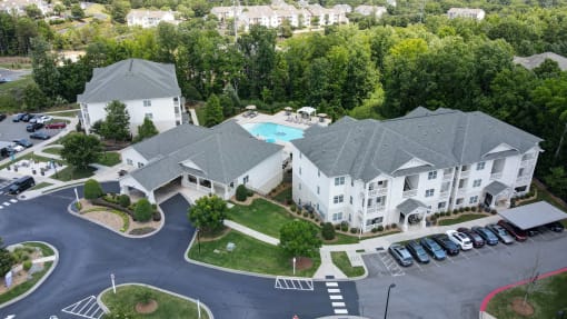 aerial view of apartment buildings, leasing office, and pool