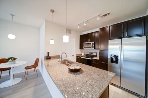 apartment kitchen with granite countertops and stainless steel applicances
