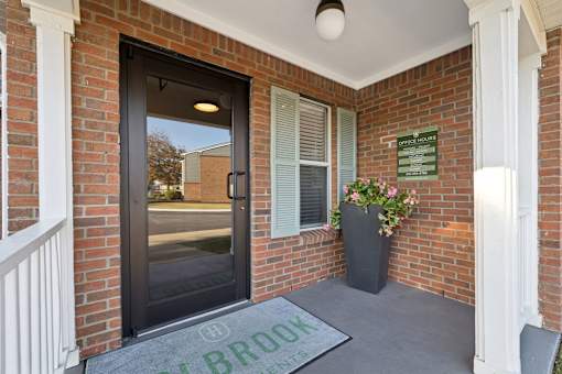 The entrance to a building with a glass door and a sign that reads "The Brooks".