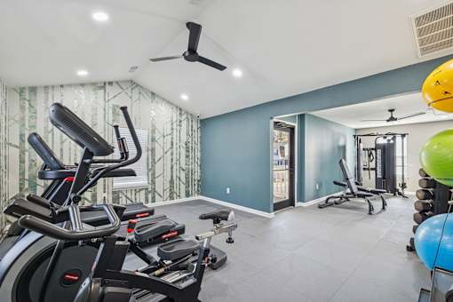 A room with a blue wall and a treadmill.