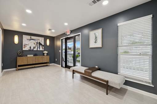 A room with a bench and a door leading outside.