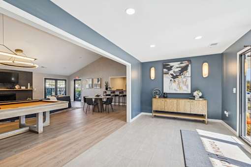 A spacious living room with a pool table and a dining table.