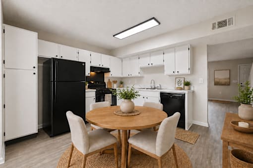 A modern kitchen with a table set for two.