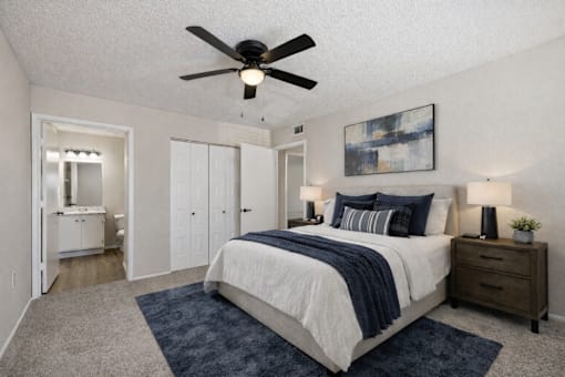A bedroom with a bed, dresser, and mirror.