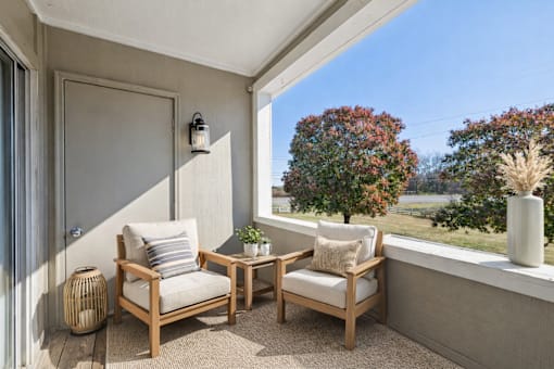 A patio with a table and two chairs.