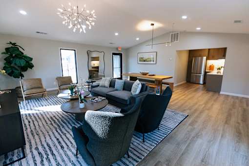 A living room with a grey couch and a wooden coffee table.