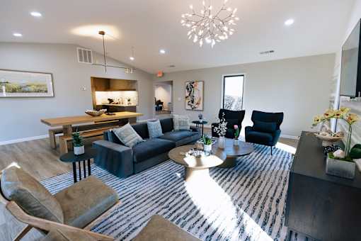 A living room with a blue couch and a wooden table.