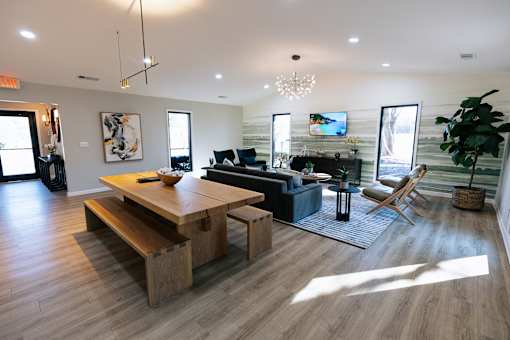 A modern living room with a wooden floor and furniture.
