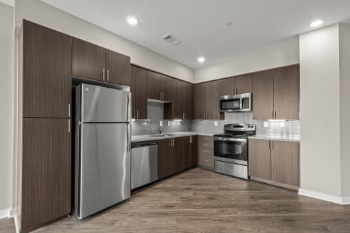 a kitchen with wooden cabinets and stainless steel appliances