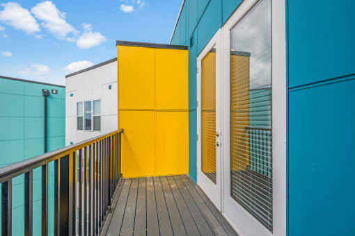 a yellow door on a blue building