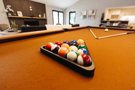 a pool table in a living room with billiard balls