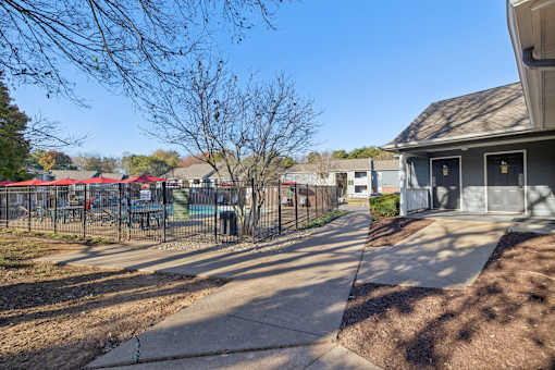 A residential area with a sidewalk and houses.