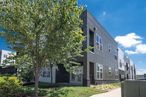 A modern building with a tree in front.