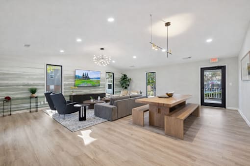 A modern living room with a black chair and a wooden coffee table.