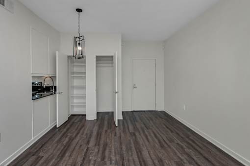 A room with a wooden floor and white walls.