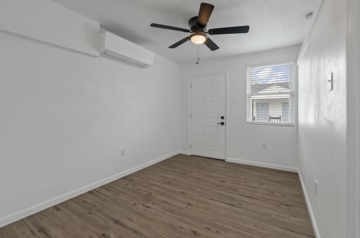 the living room of our studio apartment atrium with a ceiling fan