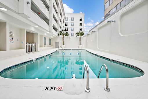 A small indoor pool with a height restriction of 8 feet.