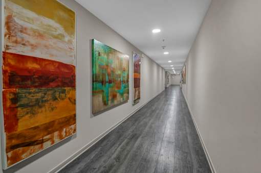 A long hallway with artwork on the wall.