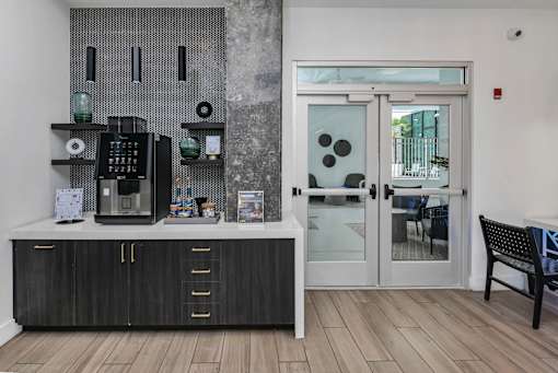 A black and white kitchen with a wooden floor.