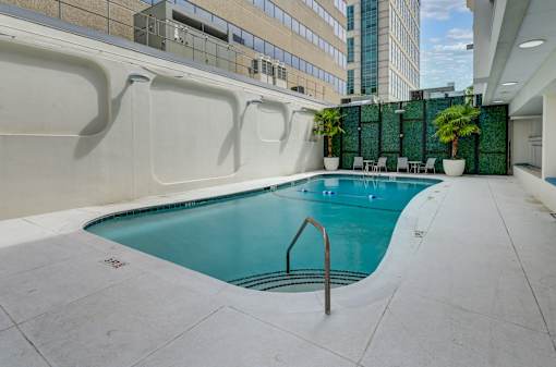 A small pool with a ladder in the middle of it.