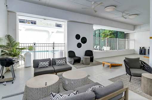 A modern living room with a grey sofa and a coffee table.