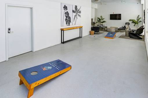 A room with a blue table in the middle and a white door.