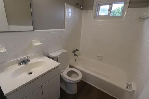 A white sink and toilet in a bathroom.