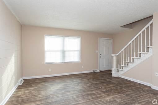 A room with a staircase and a window.
