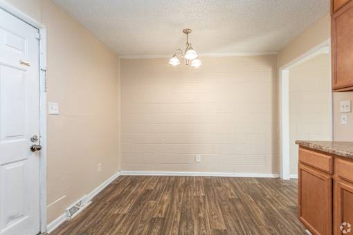 A room with wooden floors and a white door.