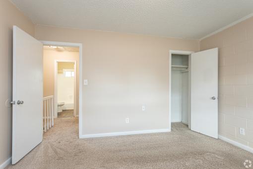 A room with a carpeted floor and white walls.