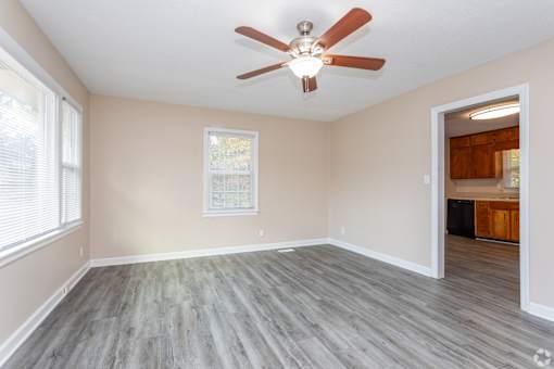 A room with a ceiling fan and a window.