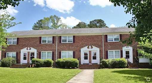 A red brick building with white doors and windows.