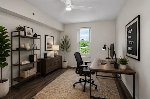 A room with a desk, chair, and shelves with decorative items.
