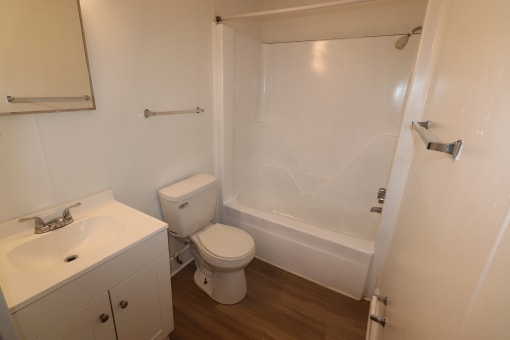 an empty bathroom with a toilet and a shower