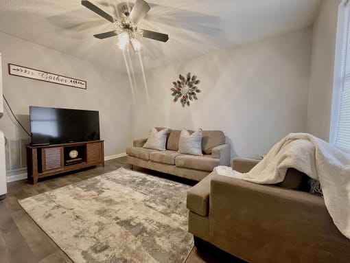 a living room with two couches and a tv